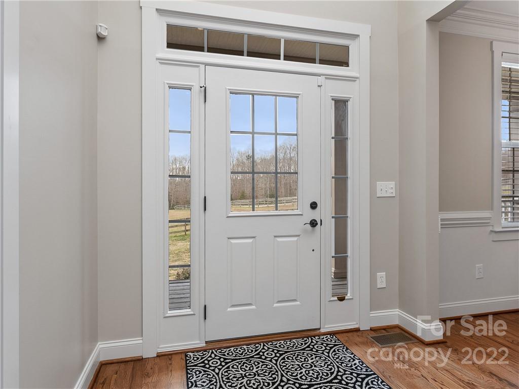 1060 Landrum Mill Road Campobello, SC 29322 - Photo 3 of 33 a view of an empty room with wooden floor and a window