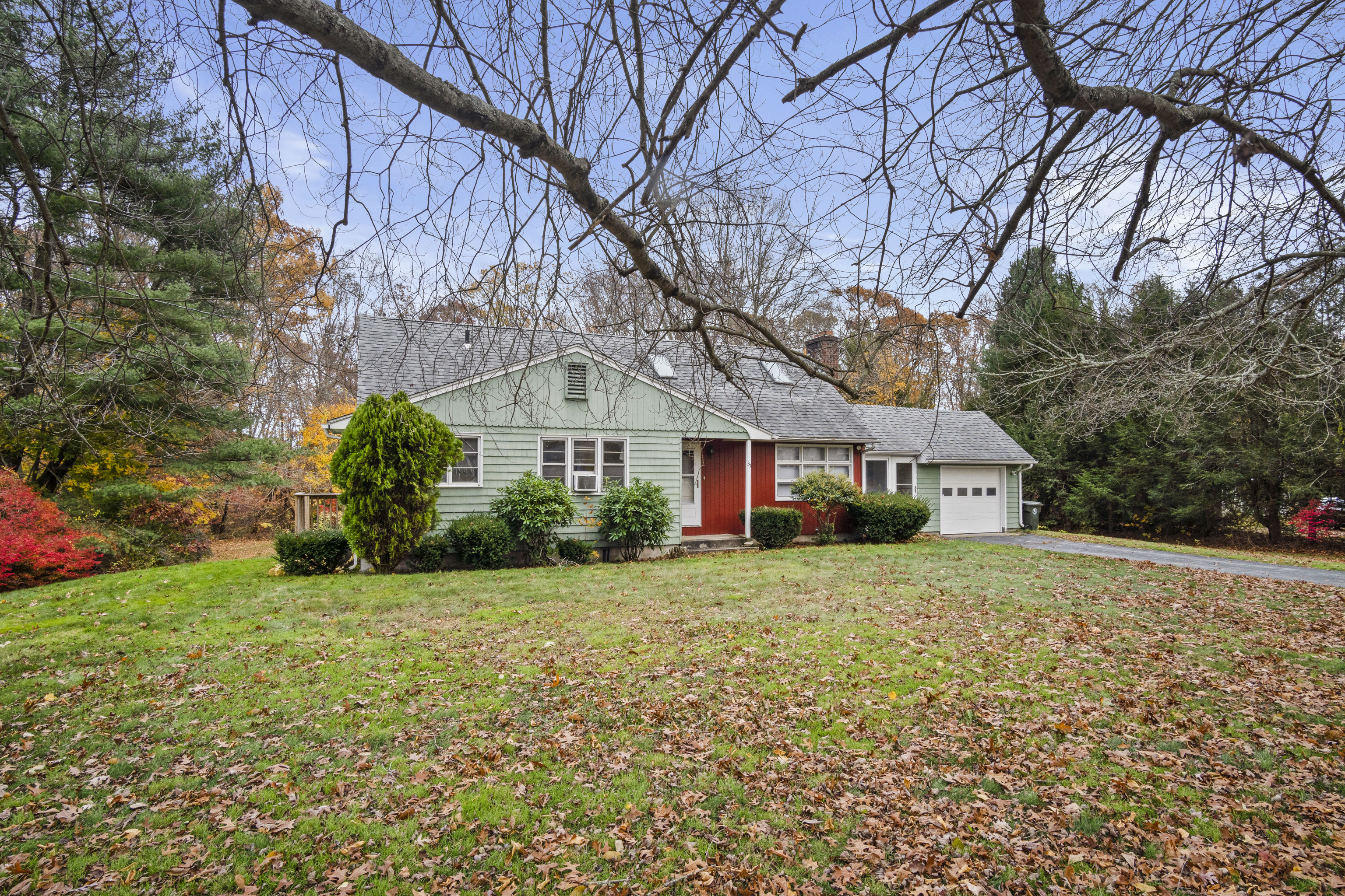33 Briar Hill Road Norwich, CT 06360 - Photo 28 of 33 a front view of a house with a yard and garage
