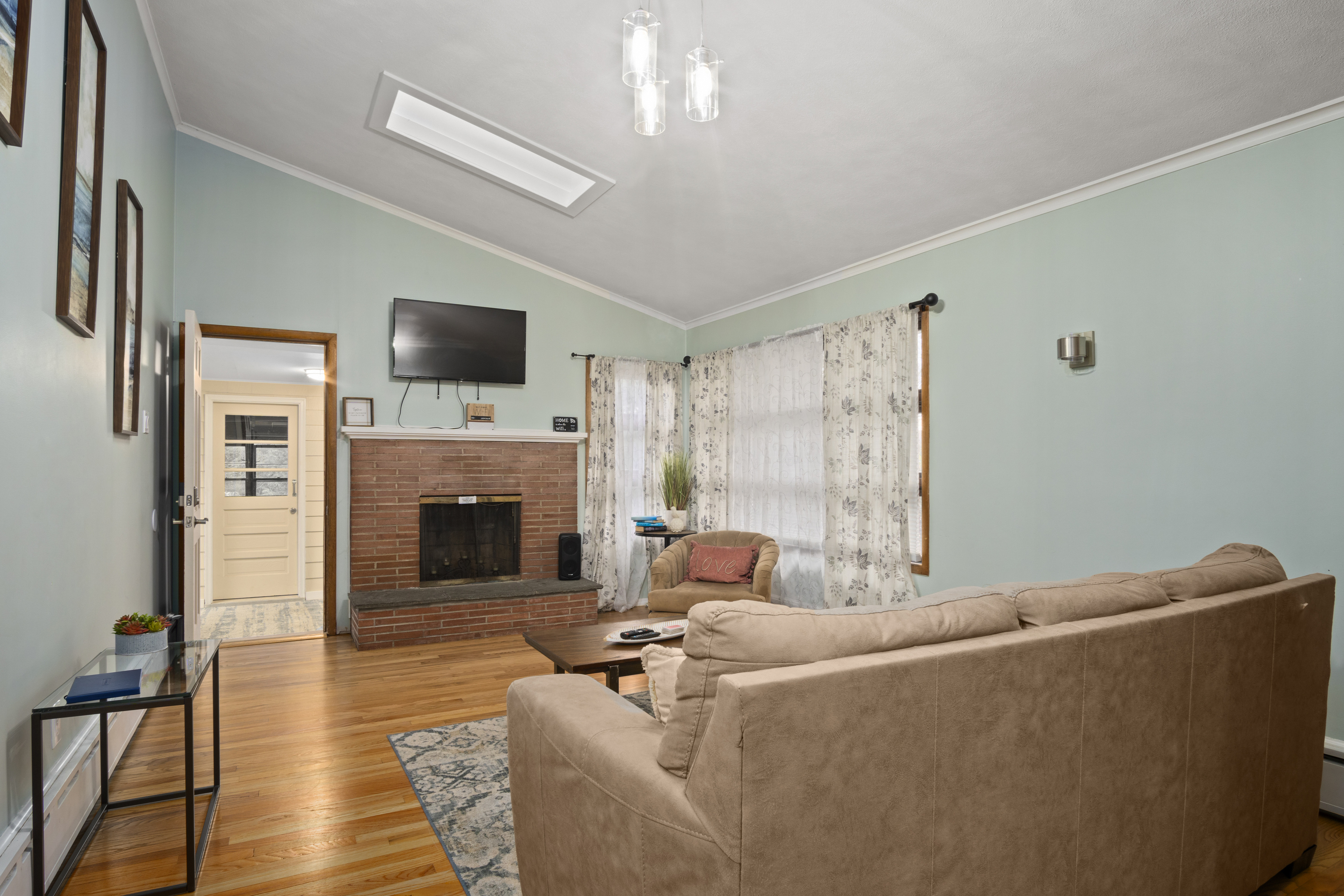 33 Briar Hill Road Norwich, CT 06360 - Photo 3 of 33 a living room with furniture a flat screen tv and a fireplace
