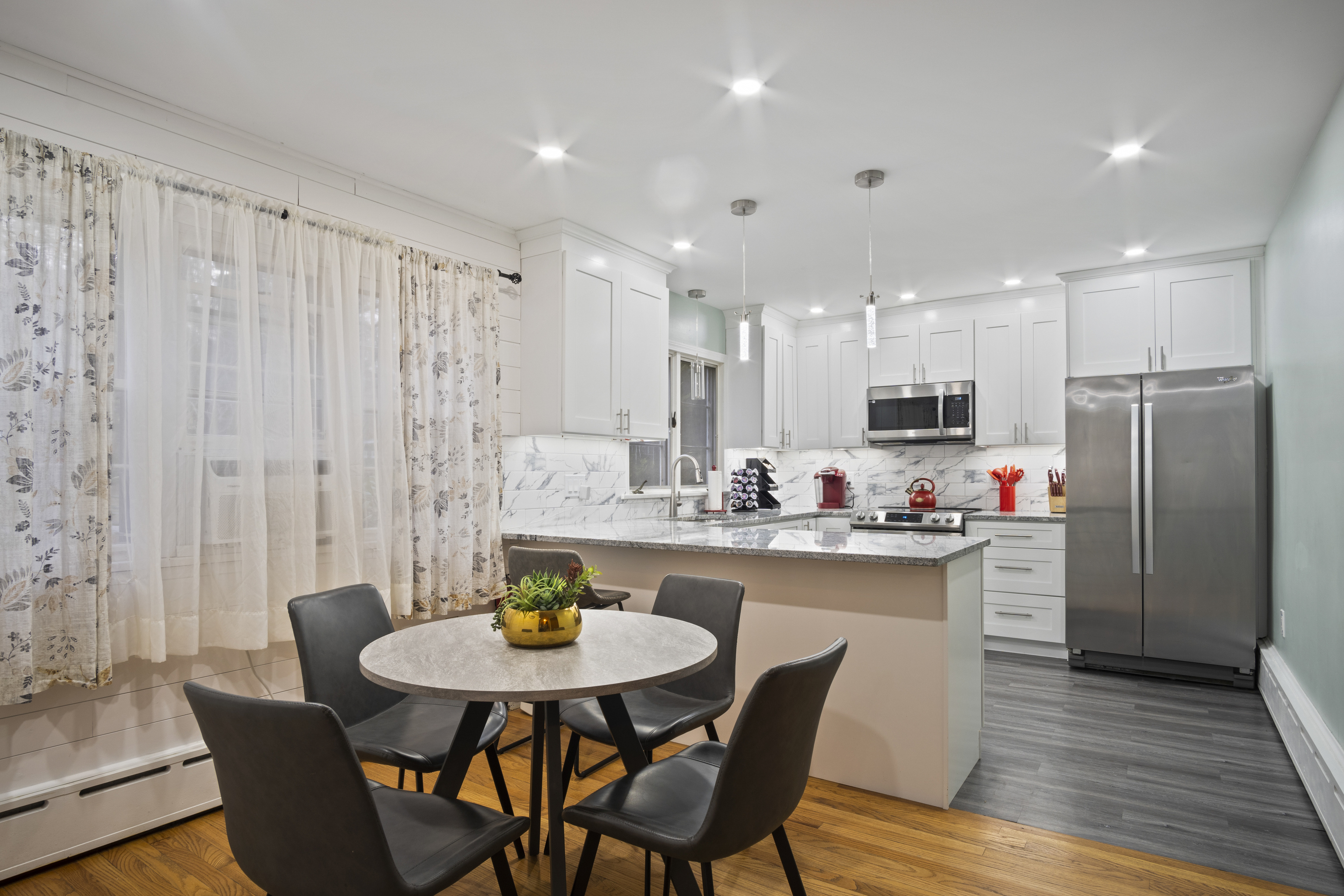 33 Briar Hill Road Norwich, CT 06360 - Photo 5 of 33 a kitchen with stainless steel appliances a dining table chairs and wooden floor
