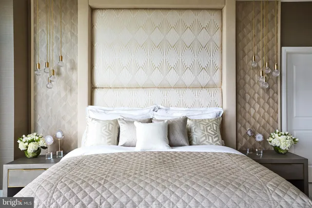 a bedroom with a large bed and a chandelier