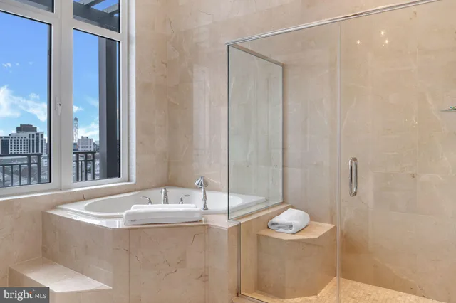 a living room with furniture a table and kitchen view