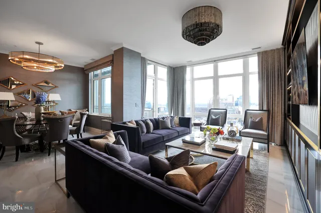 a work room with furniture and floor to ceiling window