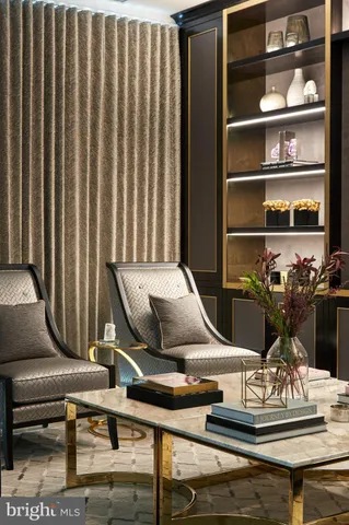 a living room with furniture a rug and a wall