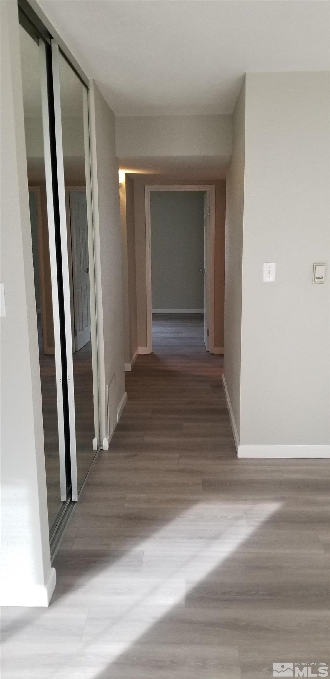 1533 Delucchi Lane Reno, NV 89502 - Photo 13 of 21 a view of a hallway view with wooden floor and staircase