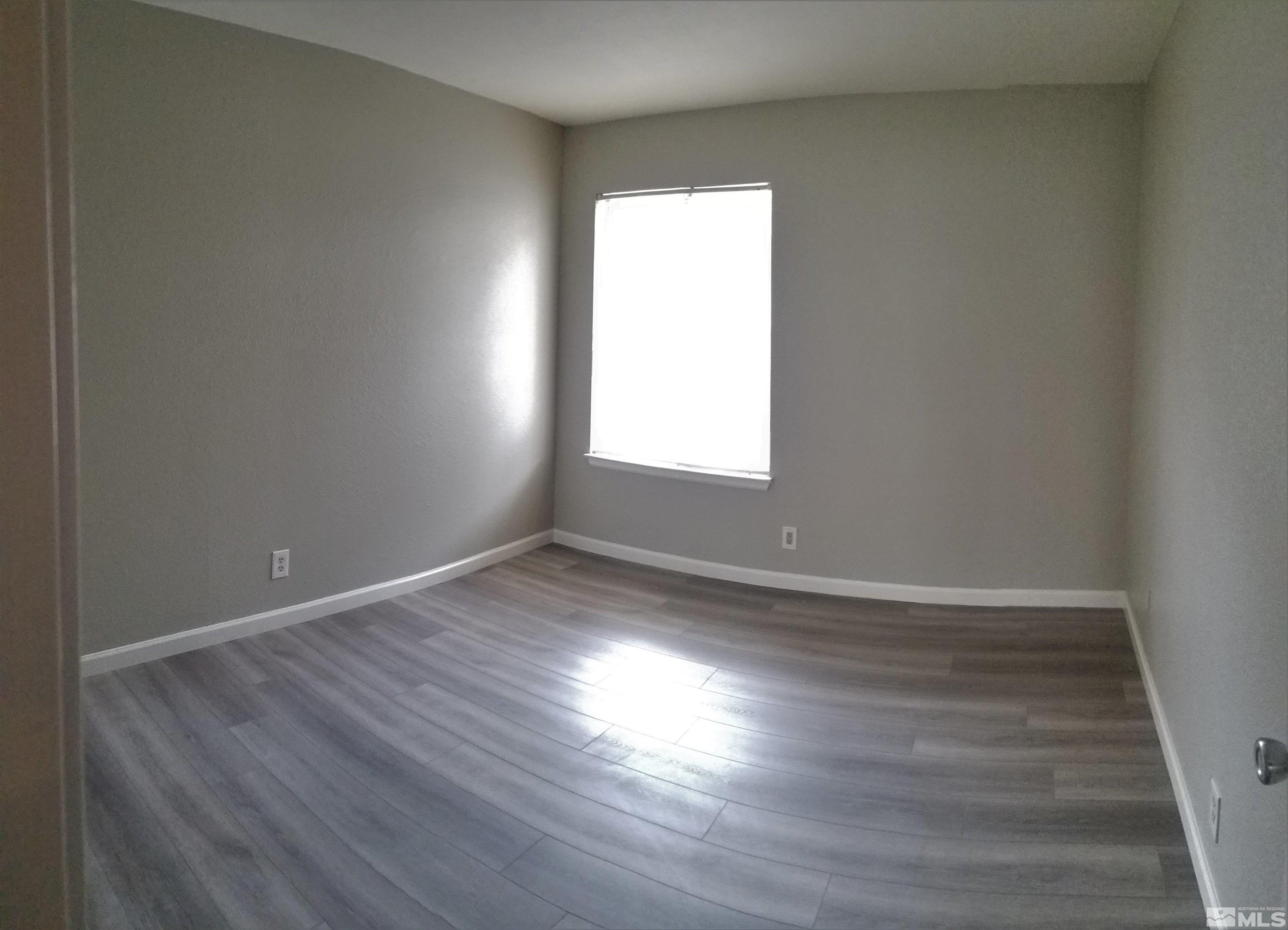1533 Delucchi Lane Reno, NV 89502 - Photo 8 of 21 an empty room with wooden floor and windows