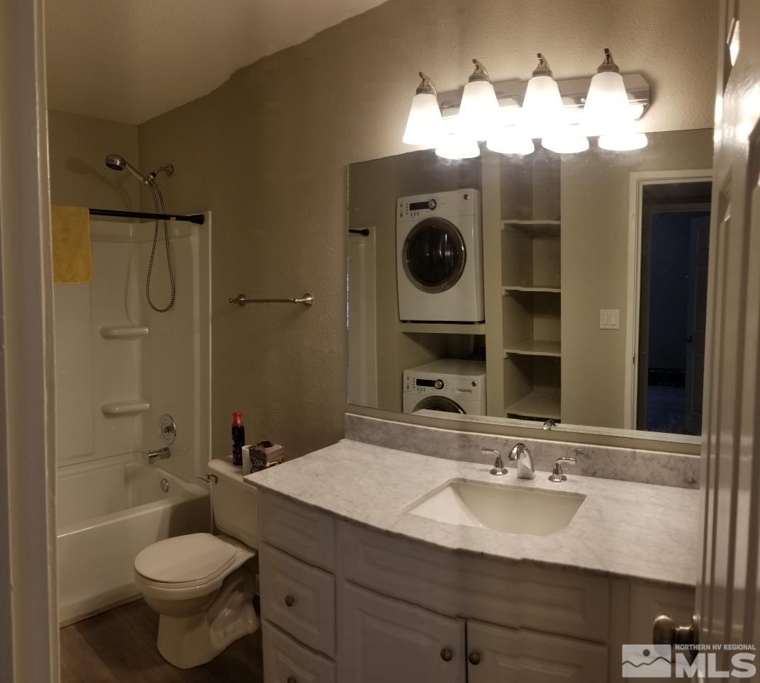 1533 Delucchi Lane Reno, NV 89502 - Photo 10 of 21 a bathroom with a toilet sink and mirror