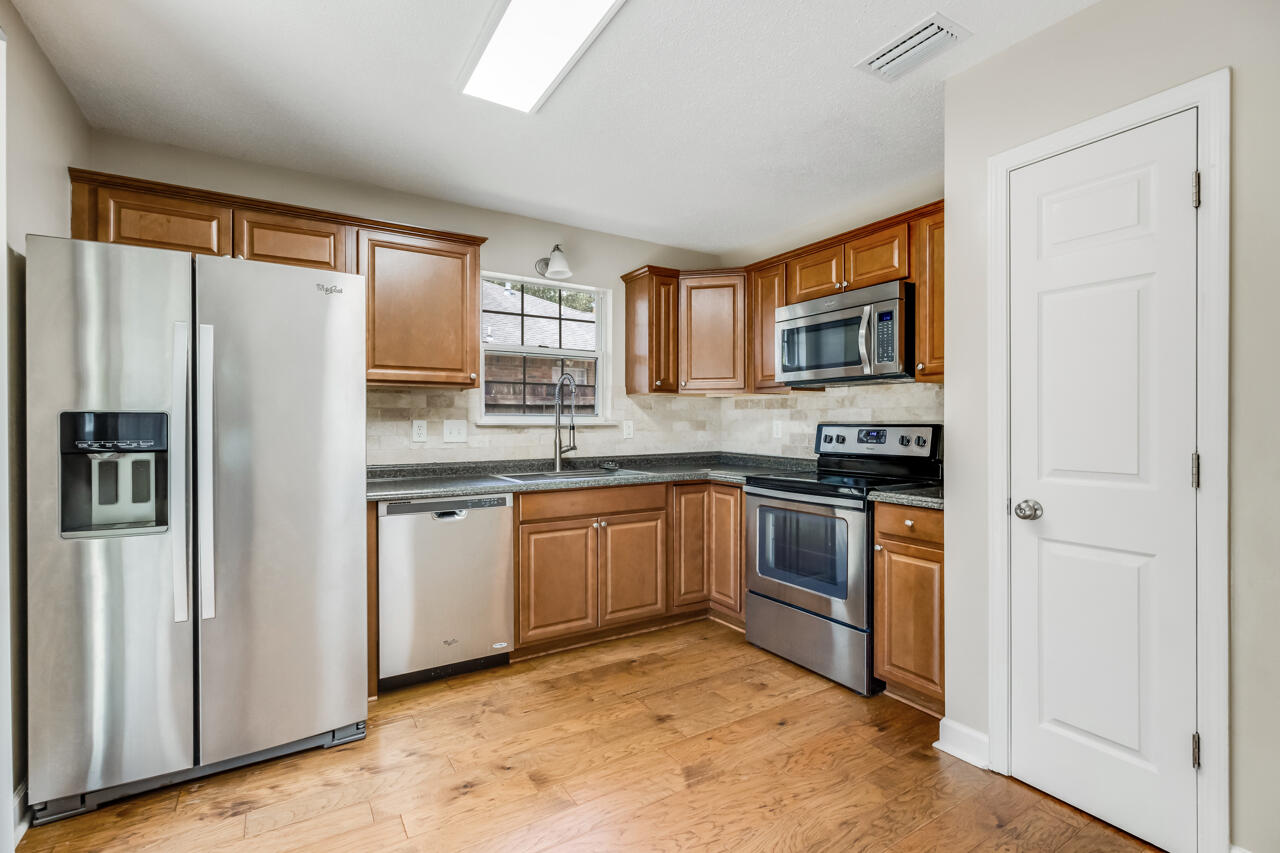 2808 Ping Lane Crestview, FL 32539 - Photo 11 of 33 a kitchen with stainless steel appliances granite countertop a refrigerator sink and stove