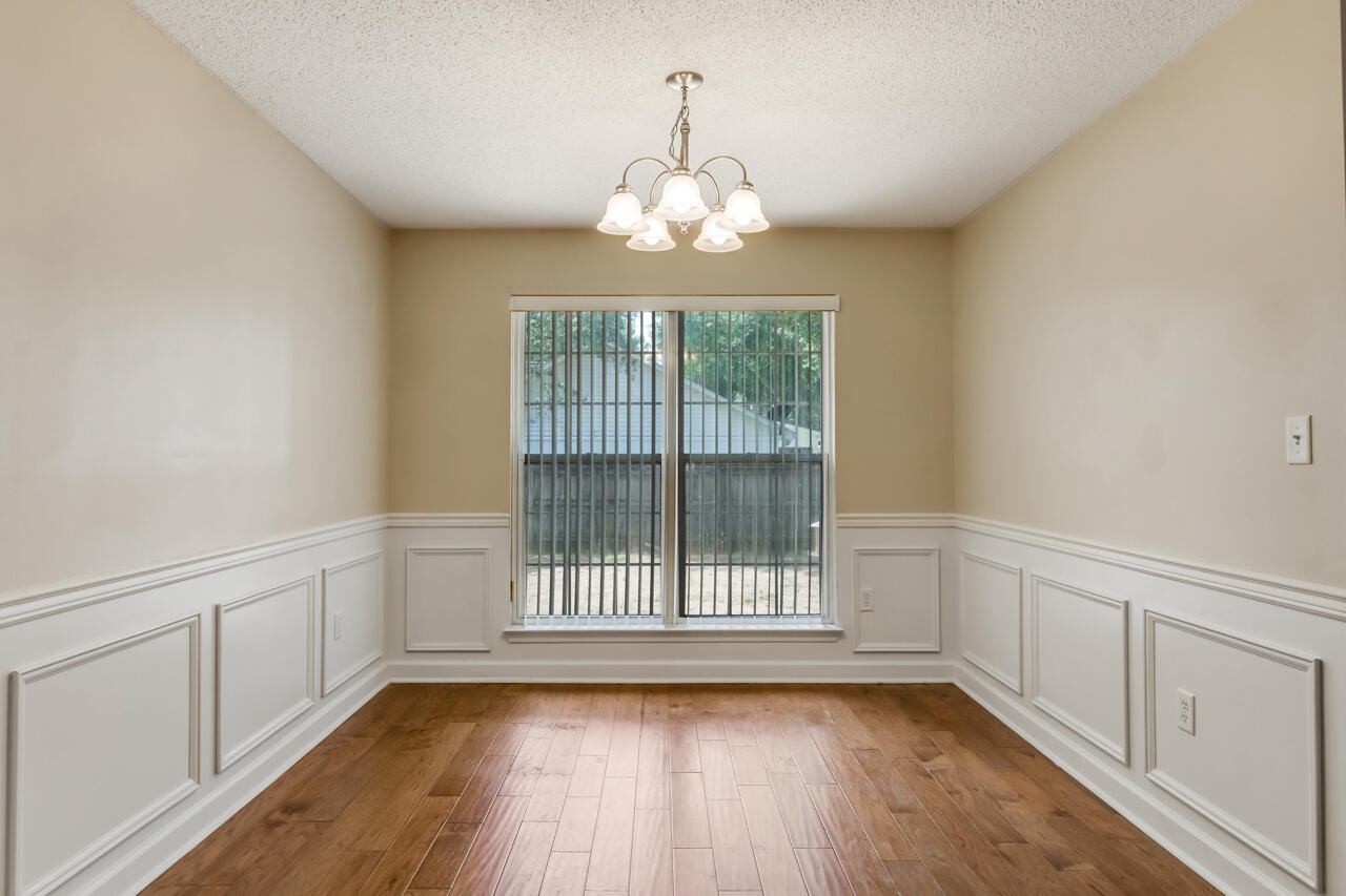 2808 Ping Lane Crestview, FL 32539 - Photo 16 of 33 a view of an empty room with wooden floor and a window