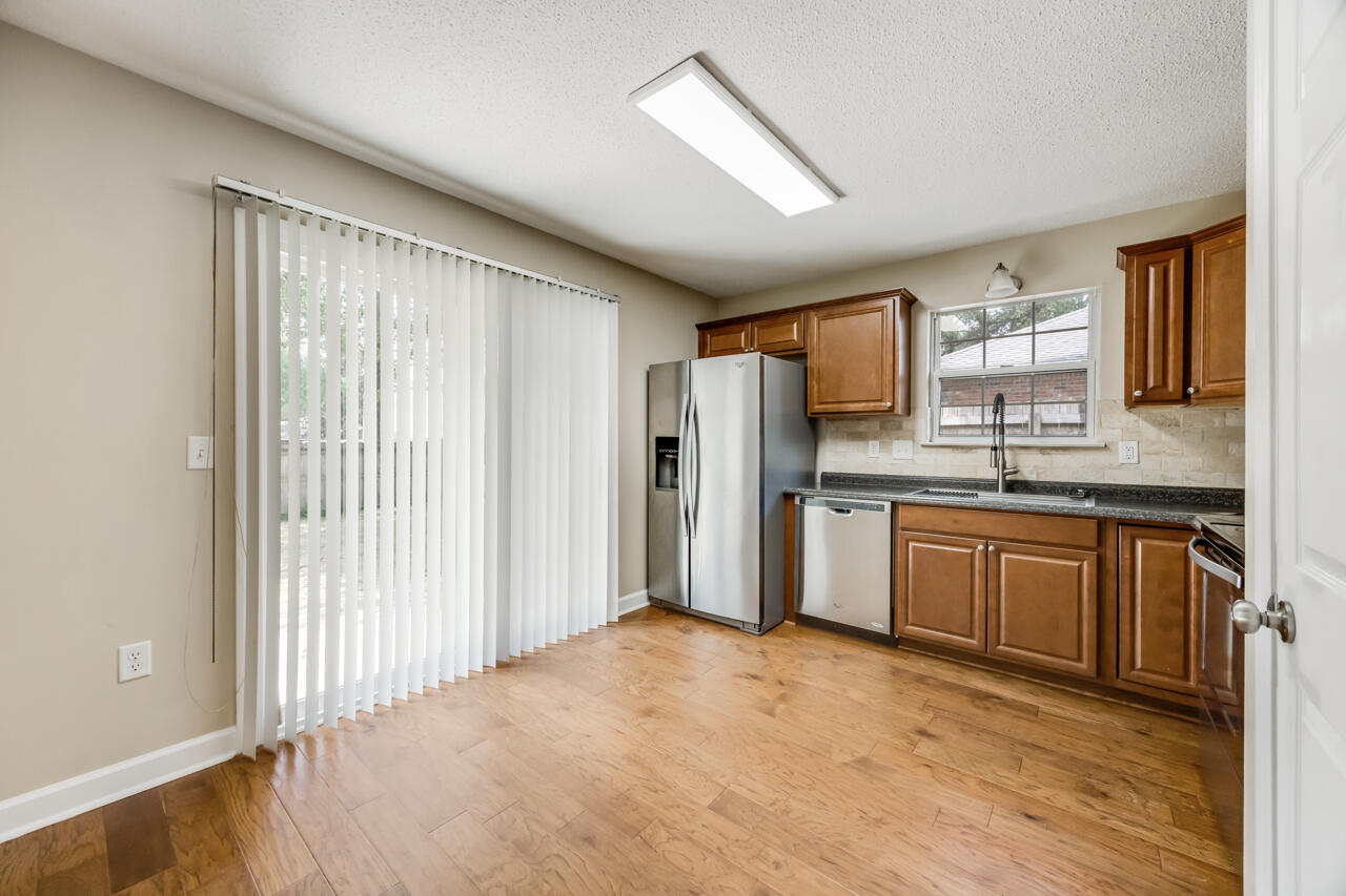 2808 Ping Lane Crestview, FL 32539 - Photo 19 of 33 a kitchen with stainless steel appliances granite countertop a refrigerator sink and cabinets