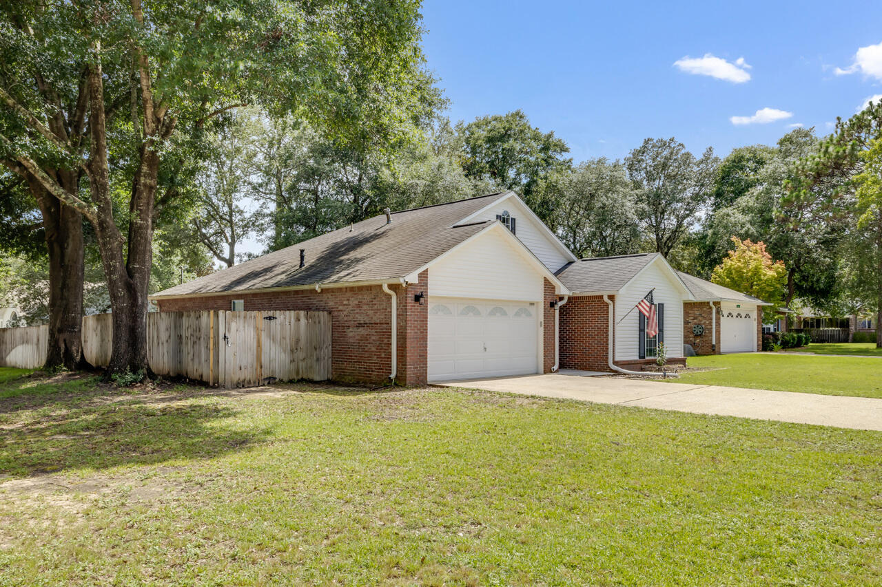 2808 Ping Lane Crestview, FL 32539 - Photo 2 of 33 a view of a yard in front of a house with large trees