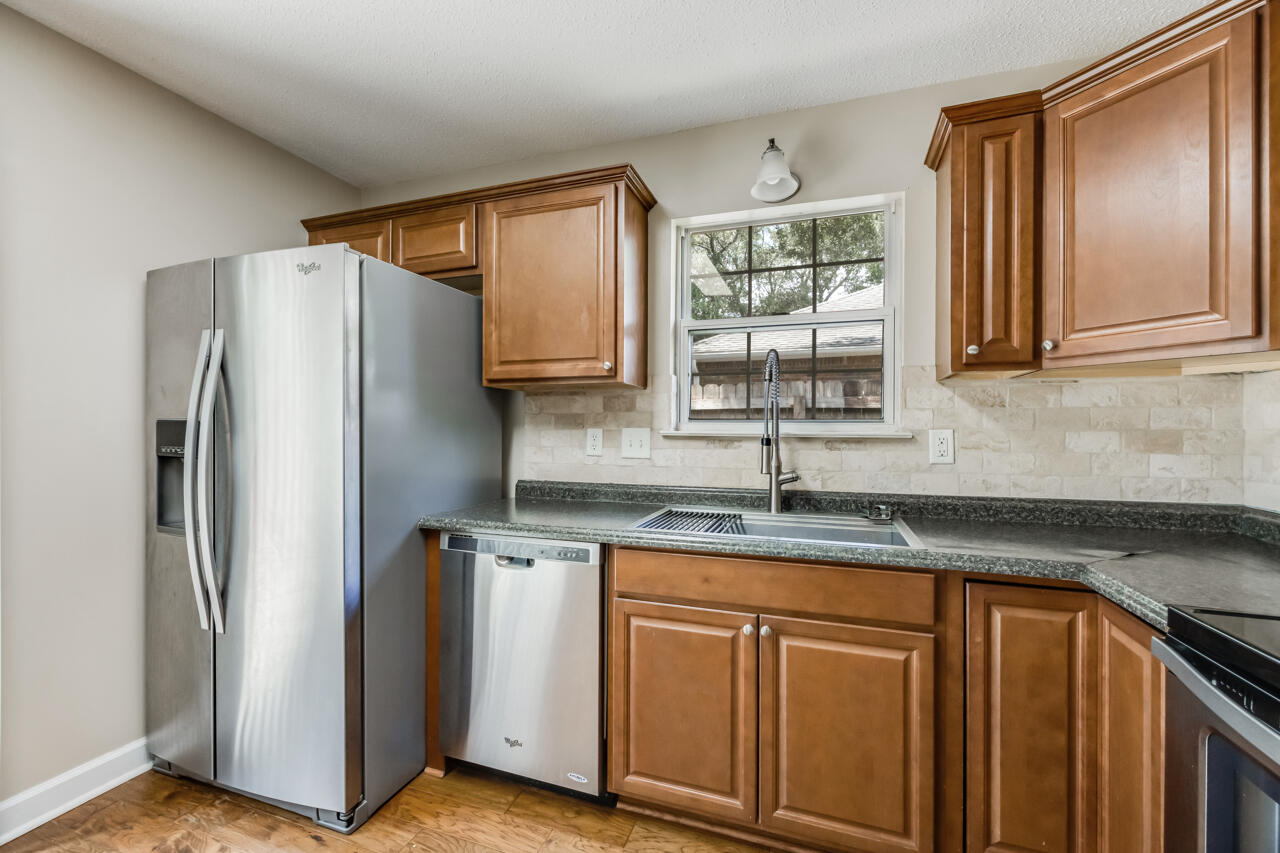 2808 Ping Lane Crestview, FL 32539 - Photo 21 of 33 a kitchen with granite countertop a refrigerator and a sink