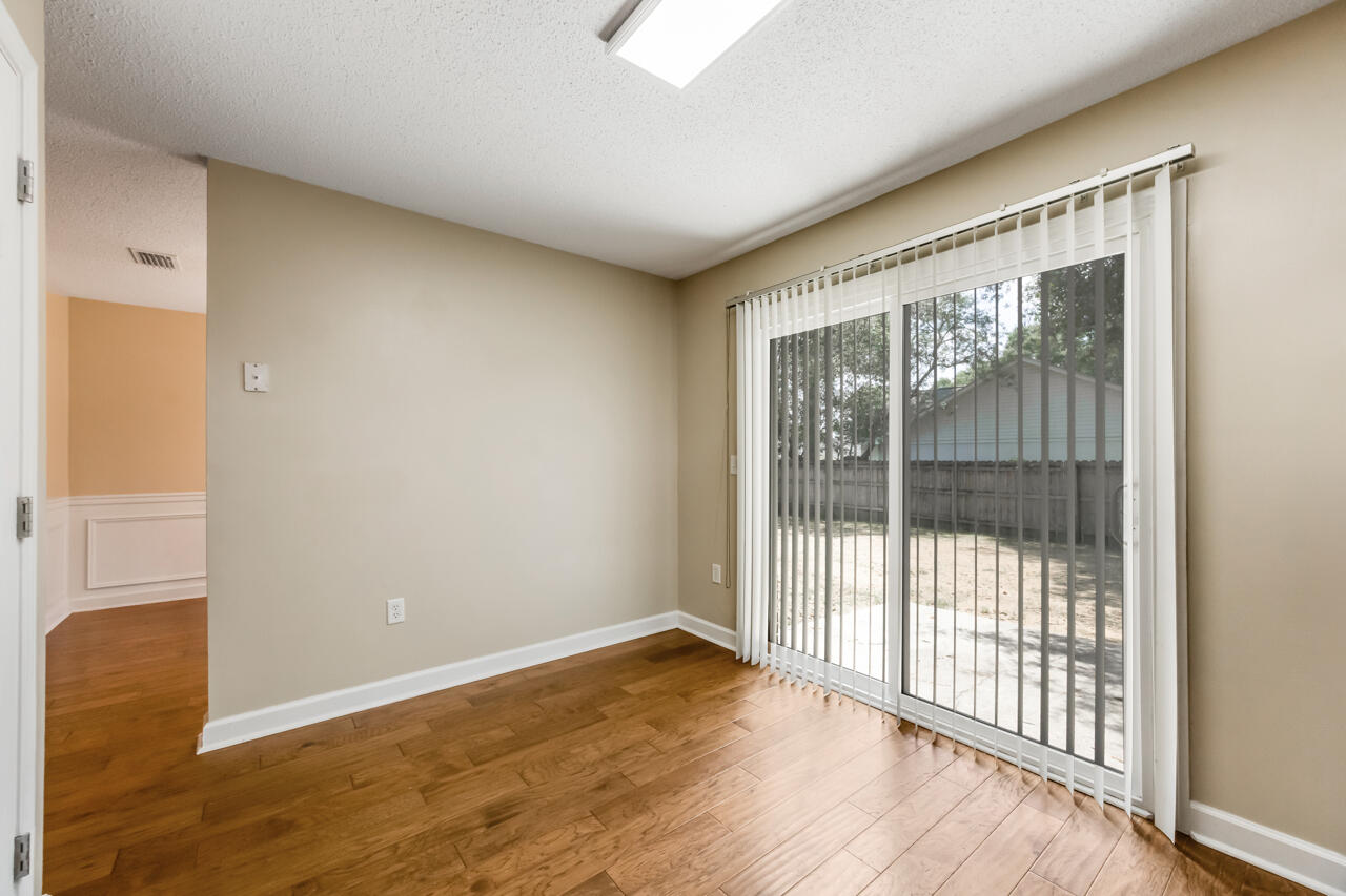 2808 Ping Lane Crestview, FL 32539 - Photo 23 of 33 a view of an empty room with wooden floor and a window