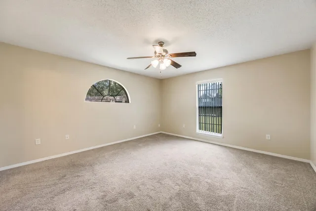 a view of an empty room with a ceiling fan