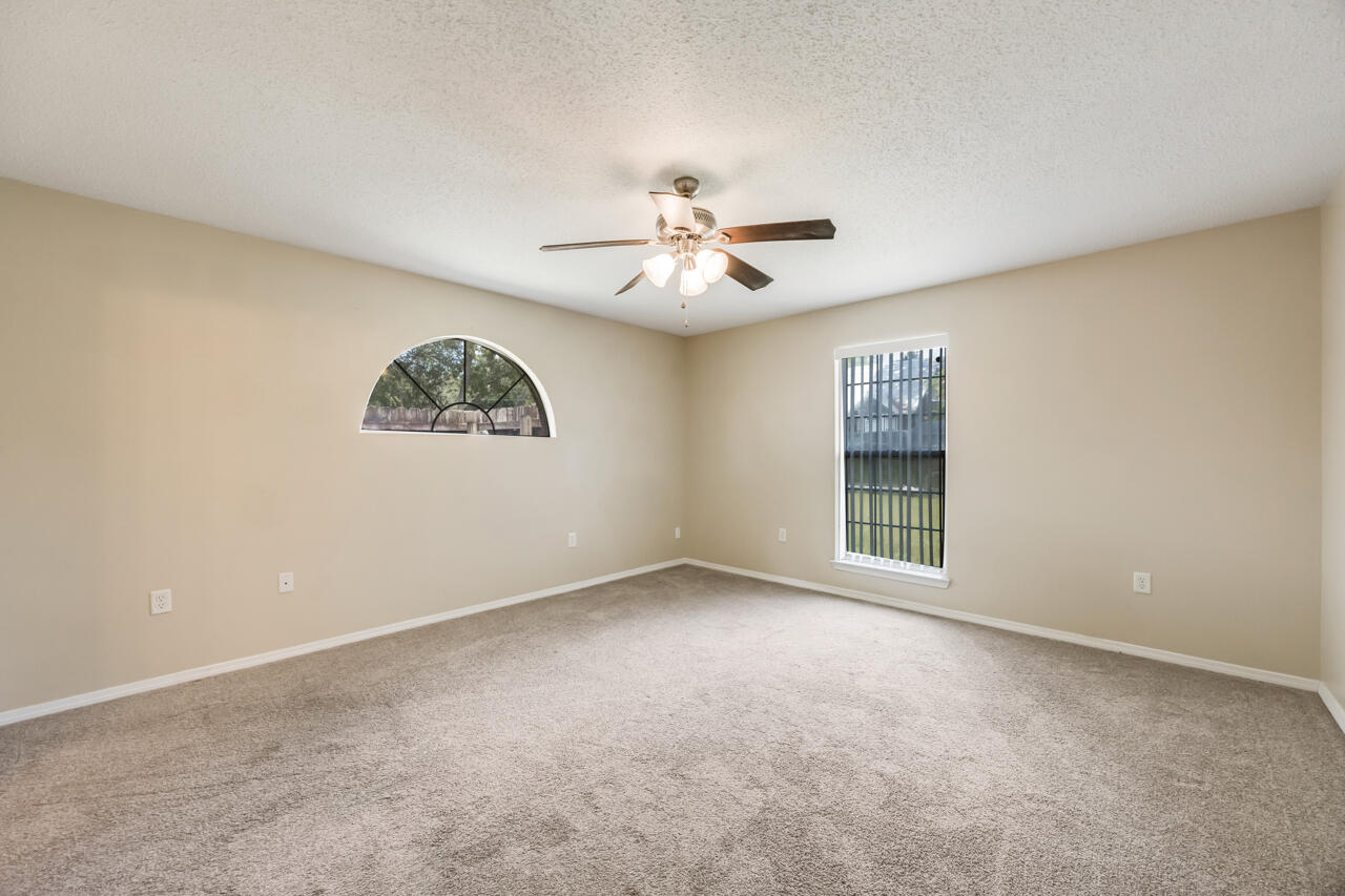 2808 Ping Lane Crestview, FL 32539 - Photo 24 of 33 a view of a big room with windows and chandelier fan