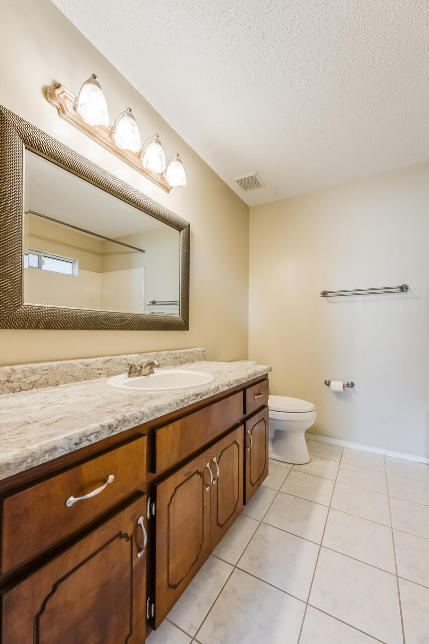 2808 Ping Lane Crestview, FL 32539 - Photo 27 of 33 a bathroom with a granite countertop sink and a mirror