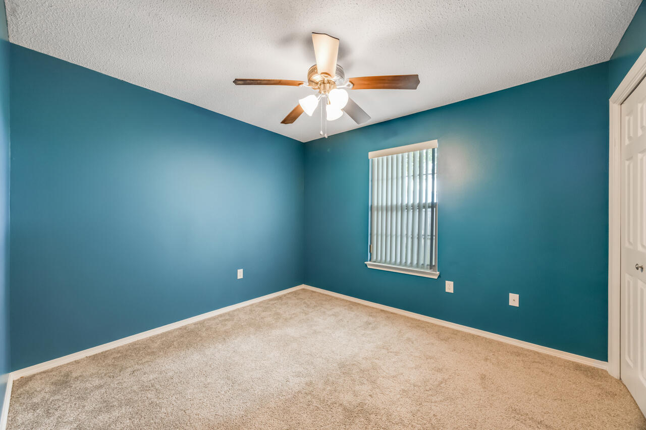 2808 Ping Lane Crestview, FL 32539 - Photo 28 of 33 an empty room with windows and ceiling fan