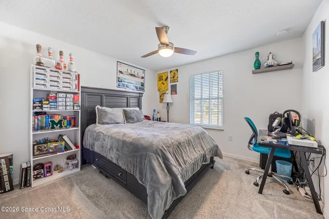 a white bath tub with a shower curtain and a sink with a curtain