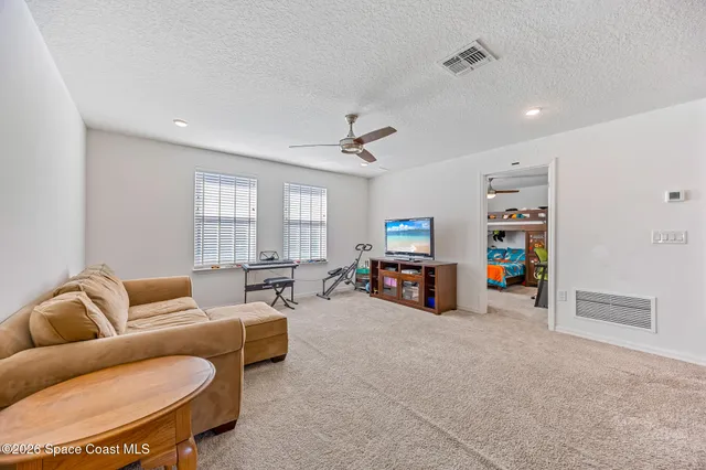 a utility room with stainless steel appliances furniture and a window