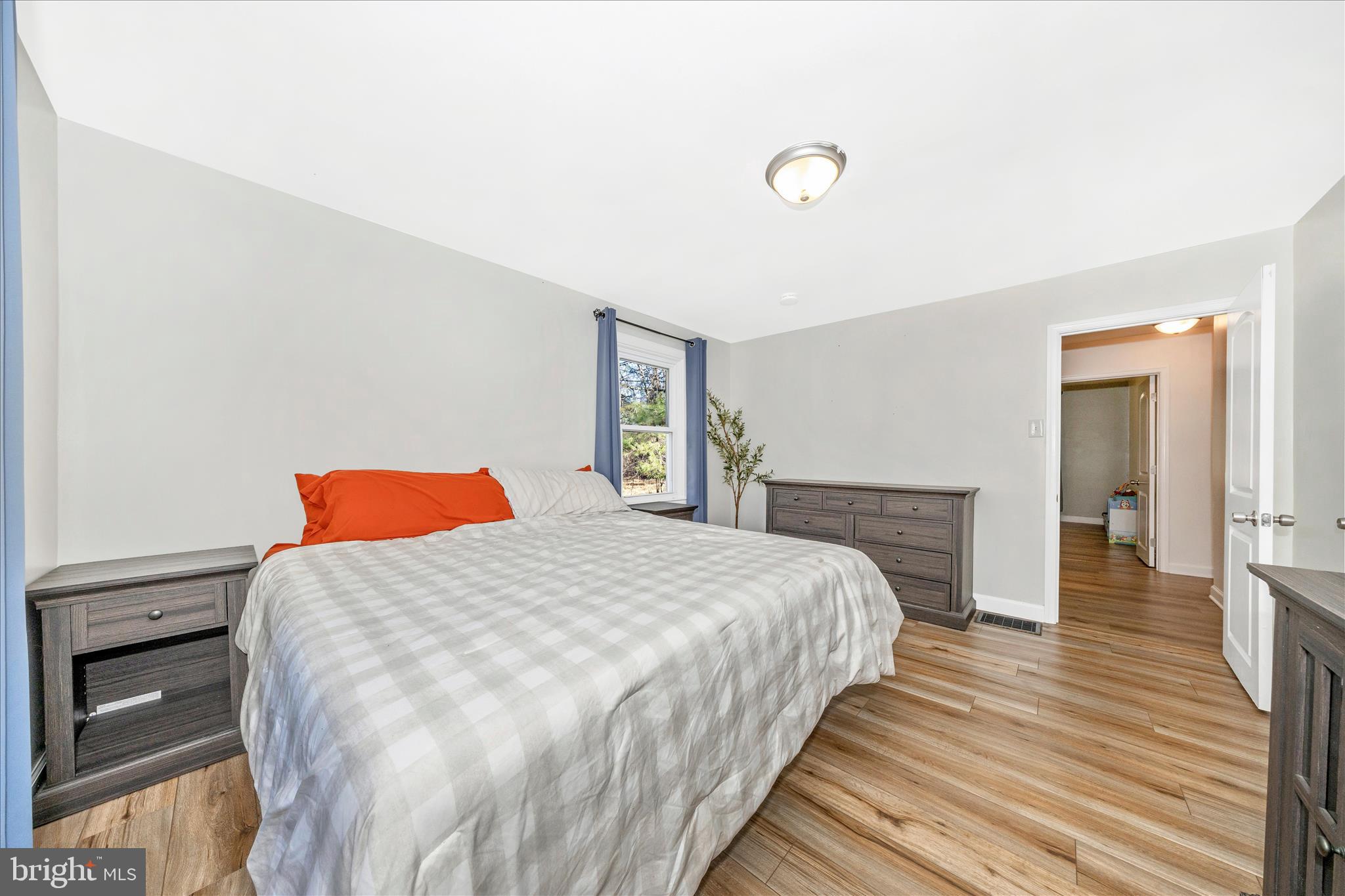 11863 Wolfsville Road Smithsburg, MD 21783 - Photo 27 of 51 a bedroom with a bed and a flat tv screen on dresser