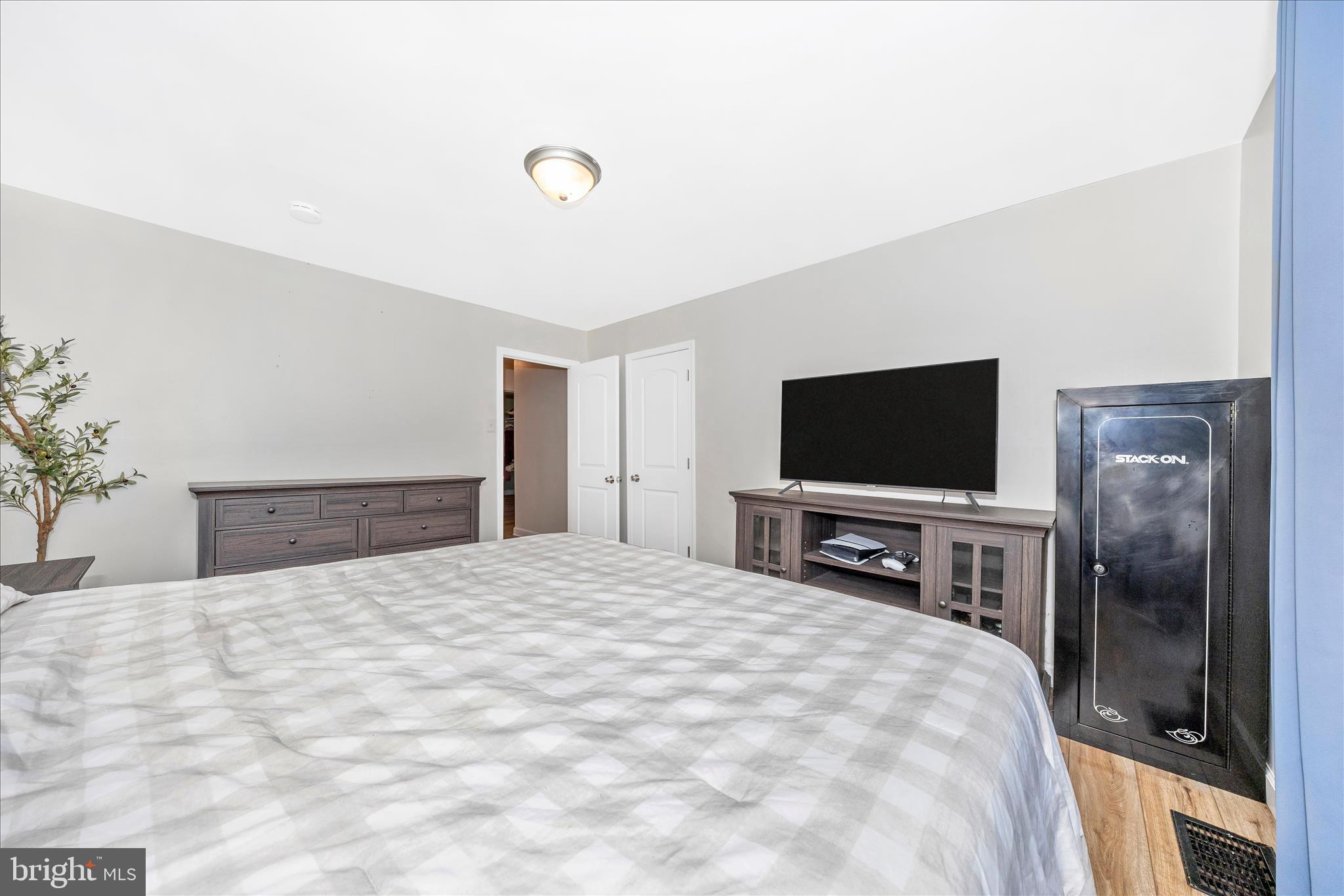 11863 Wolfsville Road Smithsburg, MD 21783 - Photo 28 of 51 a bedroom with a bed and a flat screen tv