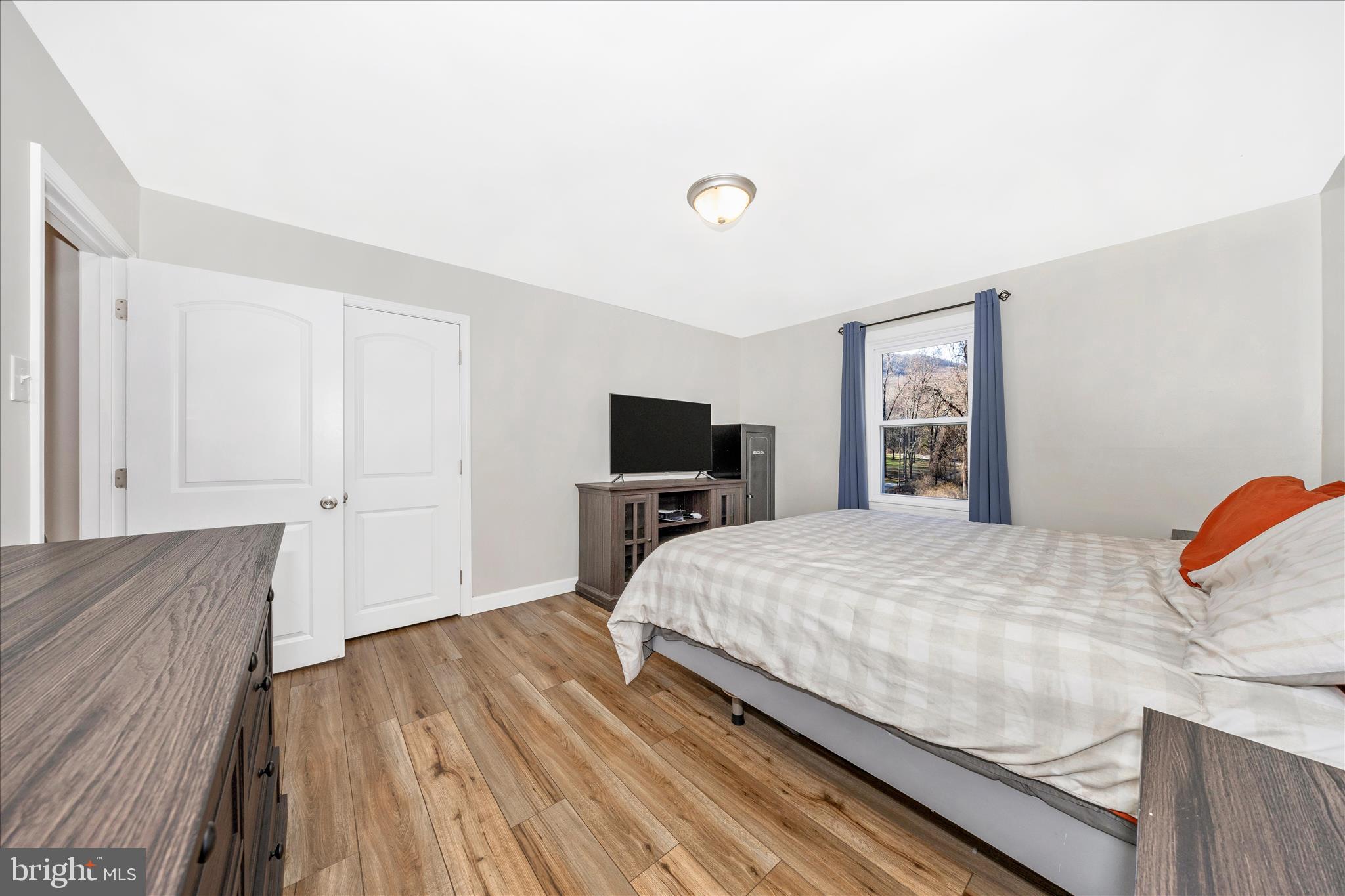 11863 Wolfsville Road Smithsburg, MD 21783 - Photo 29 of 51 a bedroom with a bed and a flat screen tv