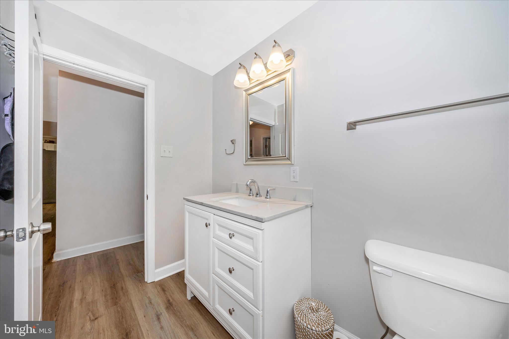 11863 Wolfsville Road Smithsburg, MD 21783 - Photo 31 of 51 a bathroom with a toilet a sink a vanity and mirror