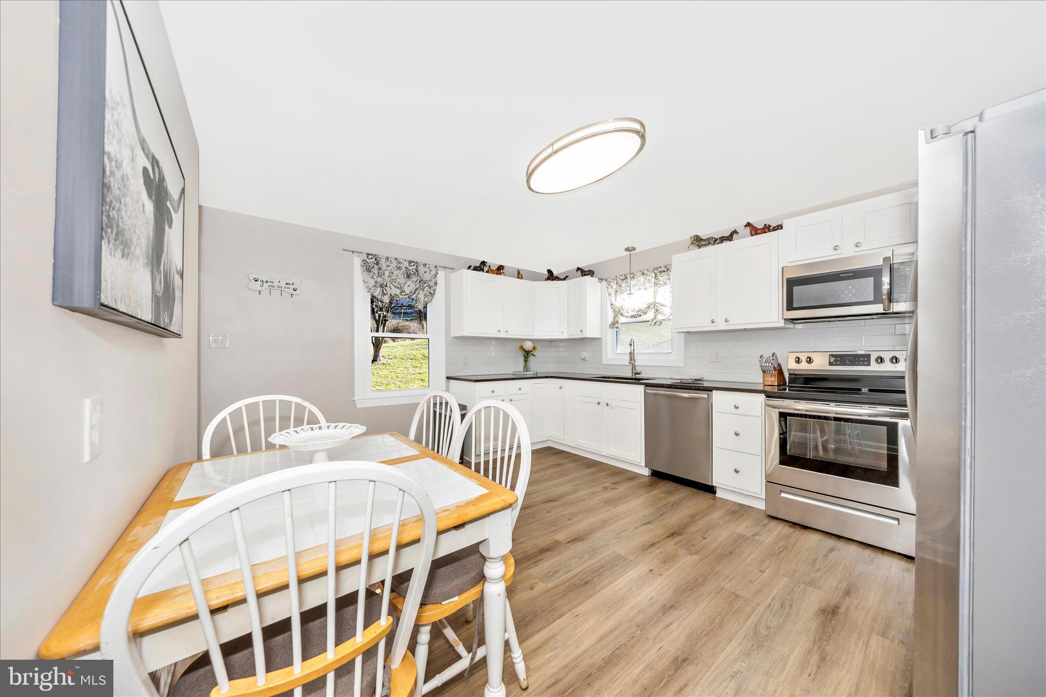 11863 Wolfsville Road Smithsburg, MD 21783 - Photo 8 of 51 a kitchen with stainless steel appliances a stove a sink dishwasher and cabinets