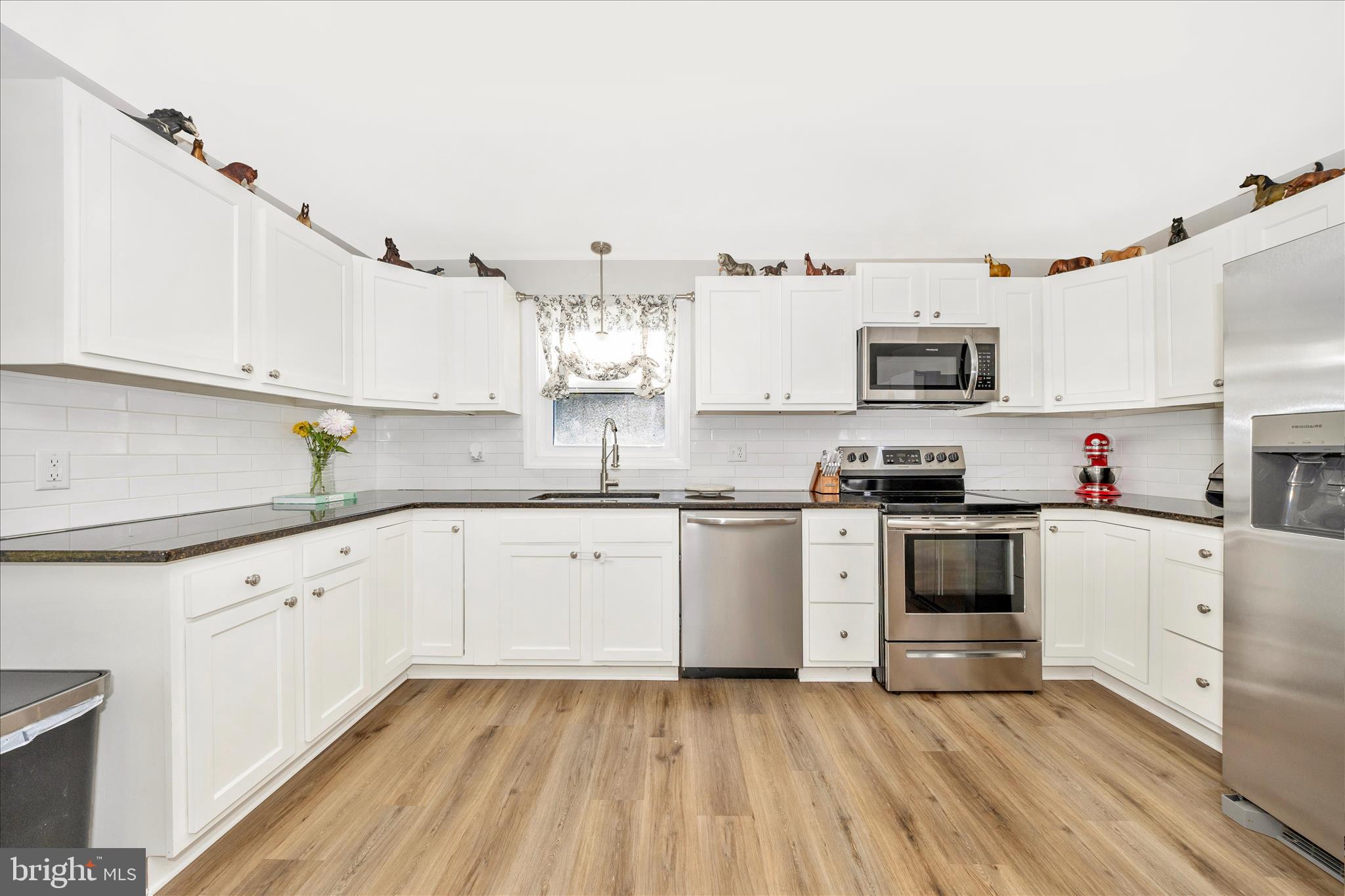 11863 Wolfsville Road Smithsburg, MD 21783 - Photo 9 of 51 a kitchen with kitchen island granite countertop a sink cabinets and stainless steel appliances