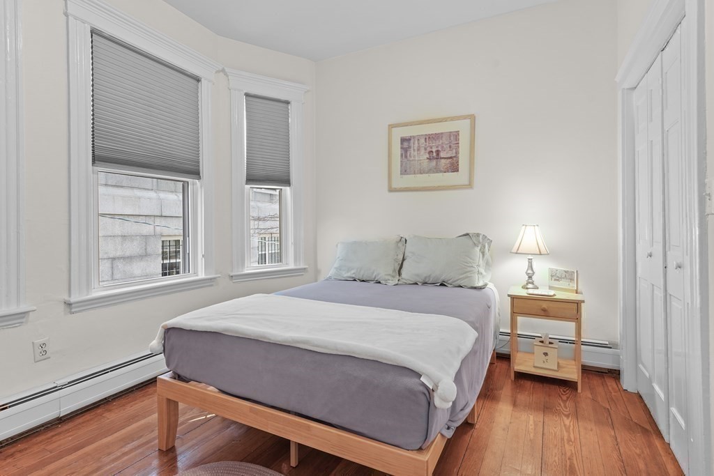 6-8 Bartlett Street, Unit 3 Boston, MA 02129 - Photo 12 of 13 a bedroom with a bed and wooden floor