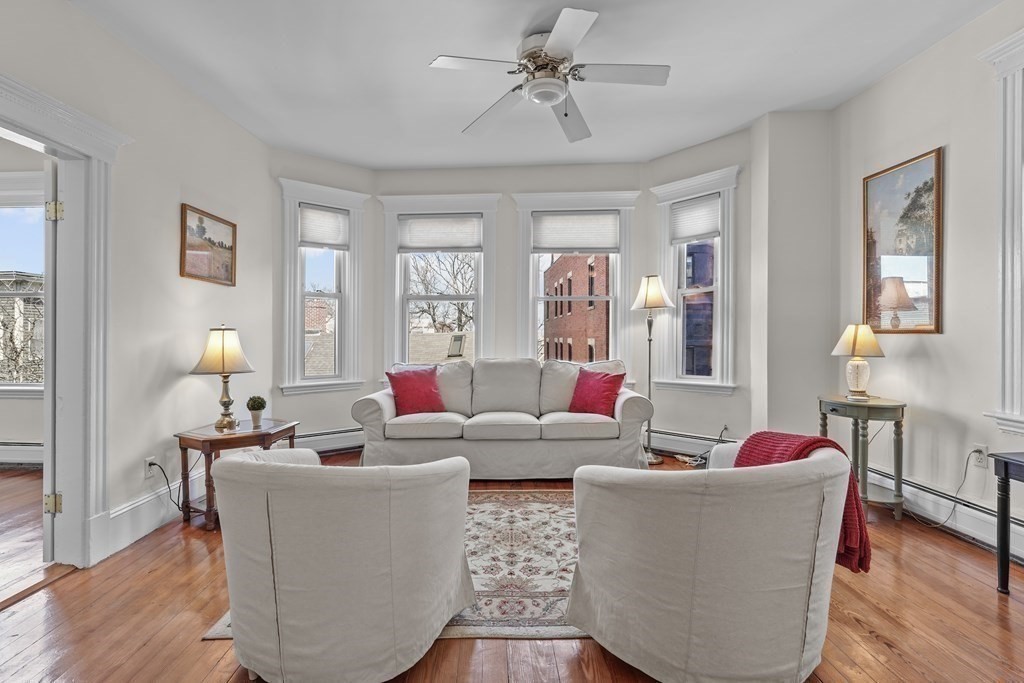 6-8 Bartlett Street, Unit 3 Boston, MA 02129 - Photo 2 of 13 a living room with furniture and wooden floor