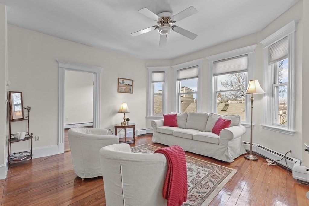 6-8 Bartlett Street, Unit 3 Boston, MA 02129 - Photo 3 of 13 a living room with furniture and a large window