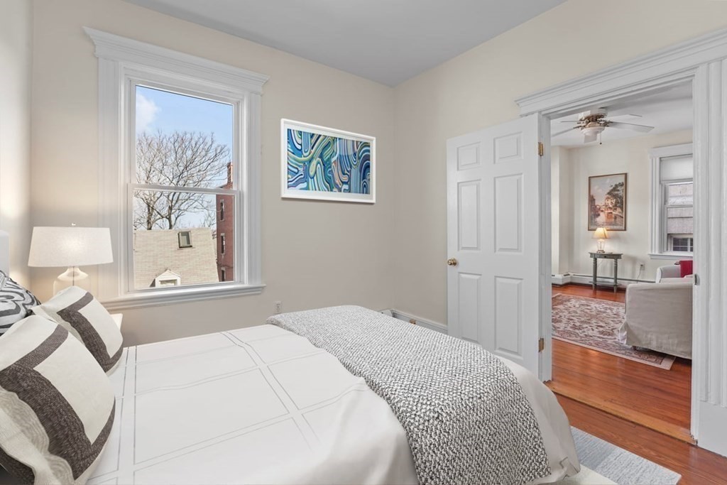 6-8 Bartlett Street, Unit 3 Boston, MA 02129 - Photo 4 of 13 a bedroom with a bed and a painting on the wall