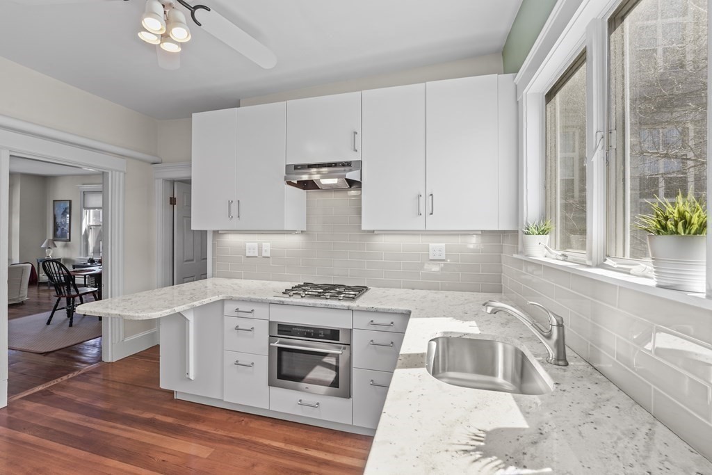 6-8 Bartlett Street, Unit 3 Boston, MA 02129 - Photo 7 of 13 a kitchen with a stove a sink and a microwave