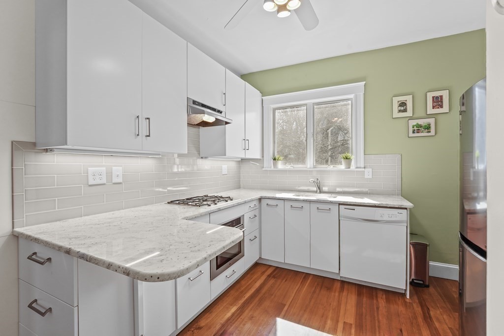 6-8 Bartlett Street, Unit 3 Boston, MA 02129 - Photo 8 of 13 a kitchen with a sink stove and cabinets