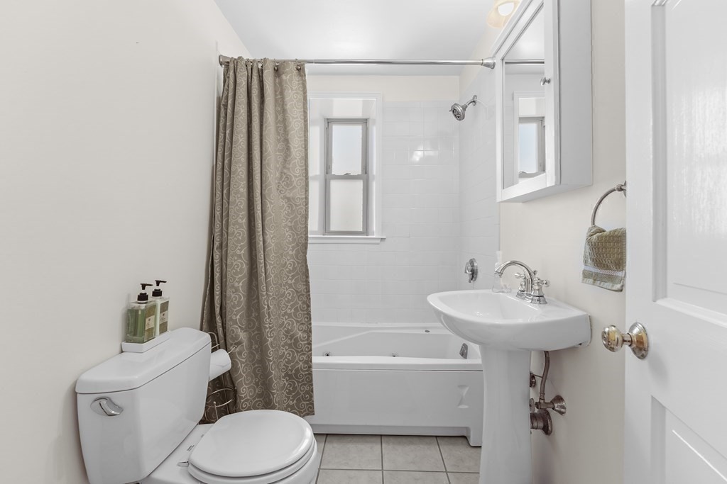 6-8 Bartlett Street, Unit 3 Boston, MA 02129 - Photo 10 of 13 a bathroom with a sink a toilet and shower