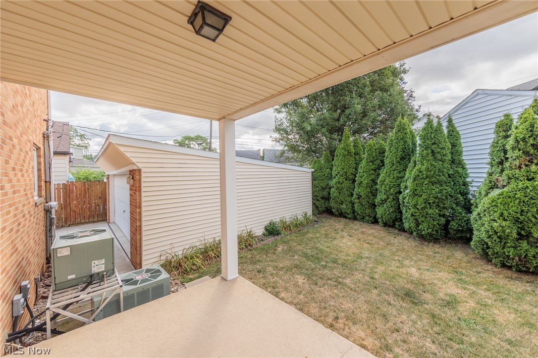 6147 Holburn Road Cleveland, OH 44129 - Photo 43 of 45 View of patio with cooling unit, a garage, and an outbuilding