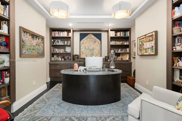 a living room with furniture and a book shelf