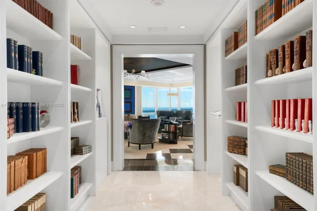 a living room with furniture and a book shelf