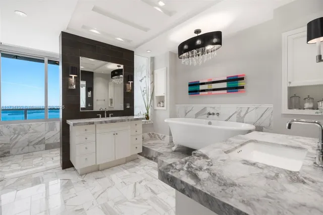 a spacious bathroom with sinks mirror and bathtub
