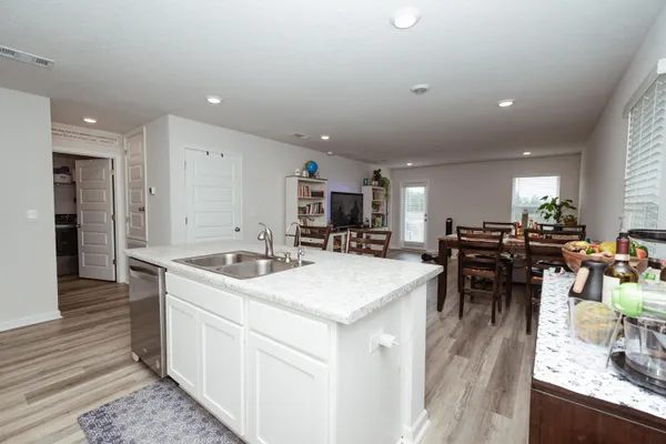 a kitchen with stainless steel appliances kitchen island granite countertop a sink and cabinets