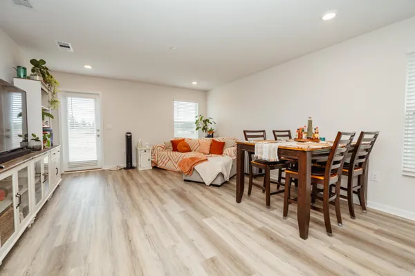 a bedroom with furniture and wooden floor