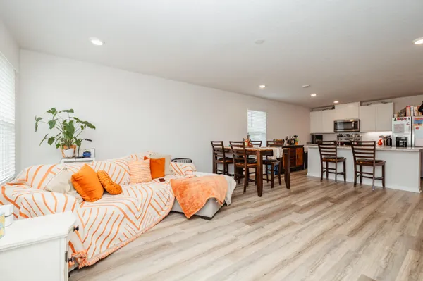 a living room with furniture and kitchen view