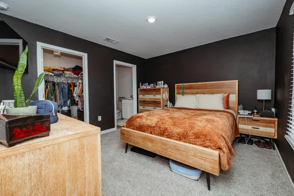 a bed room with a bed and a tv