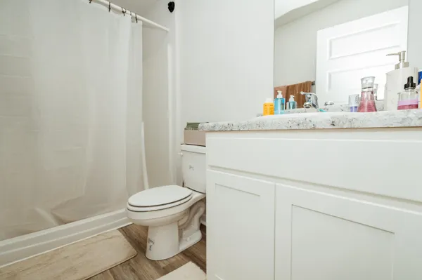 a bathroom with a sink a toilet and a mirror