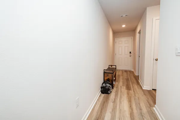 a view of a room with wooden floor