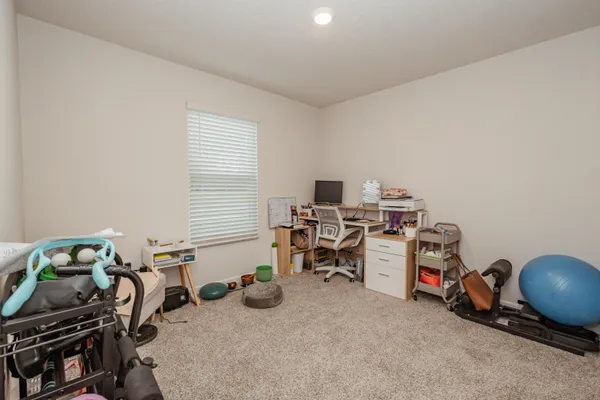 a view of a room with workspace and a window