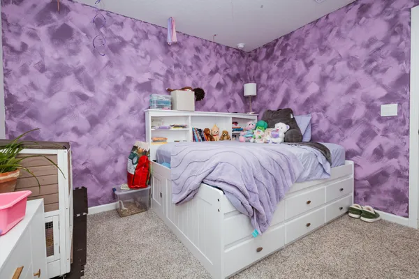 a bedroom with a bed and a couch