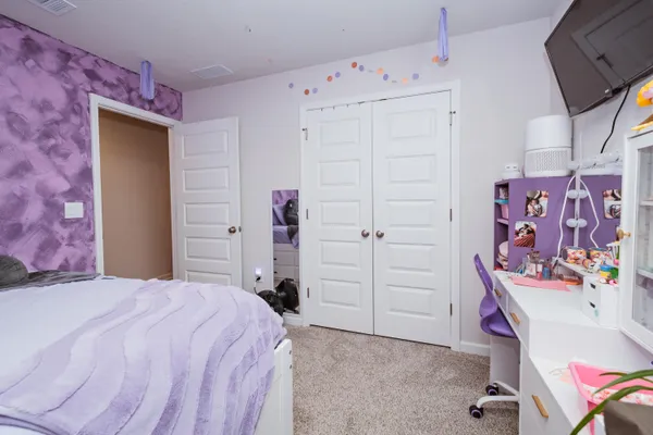 a bedroom with a bed and a dresser