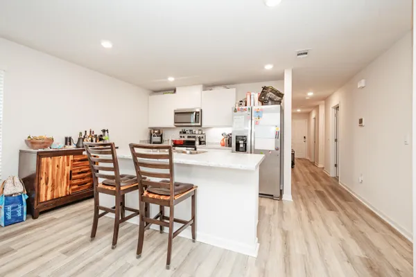 a view of a dining room with furniture and wooden floor